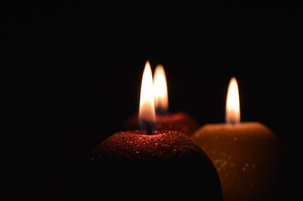 Memorial Candles Glowing in a Dark Setting for Funeral Remembrance