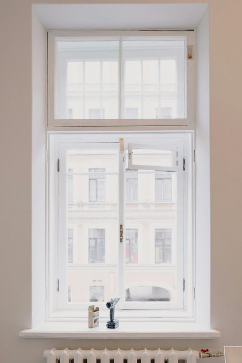 Bright window with white frame and sill in a softly lit room