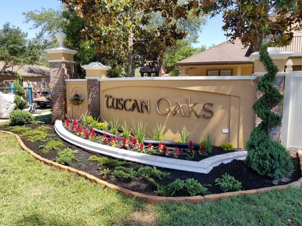 A beige entrance sign for 
