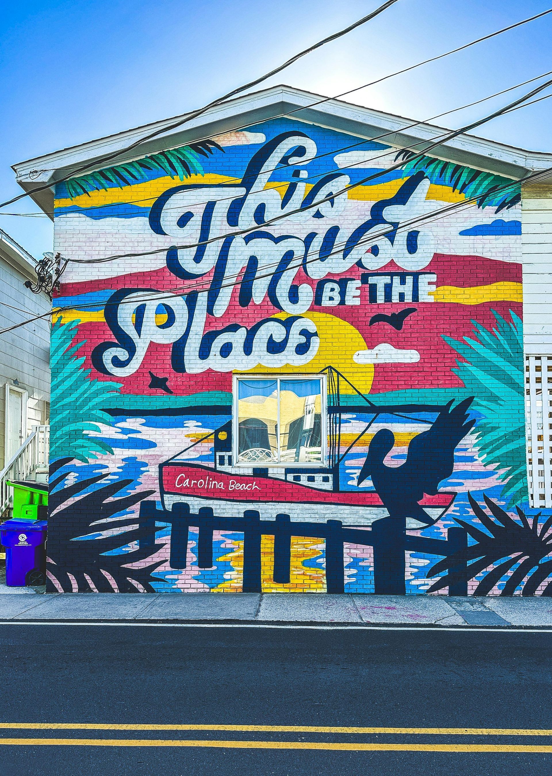 A vibrant mural on a building wall reads 