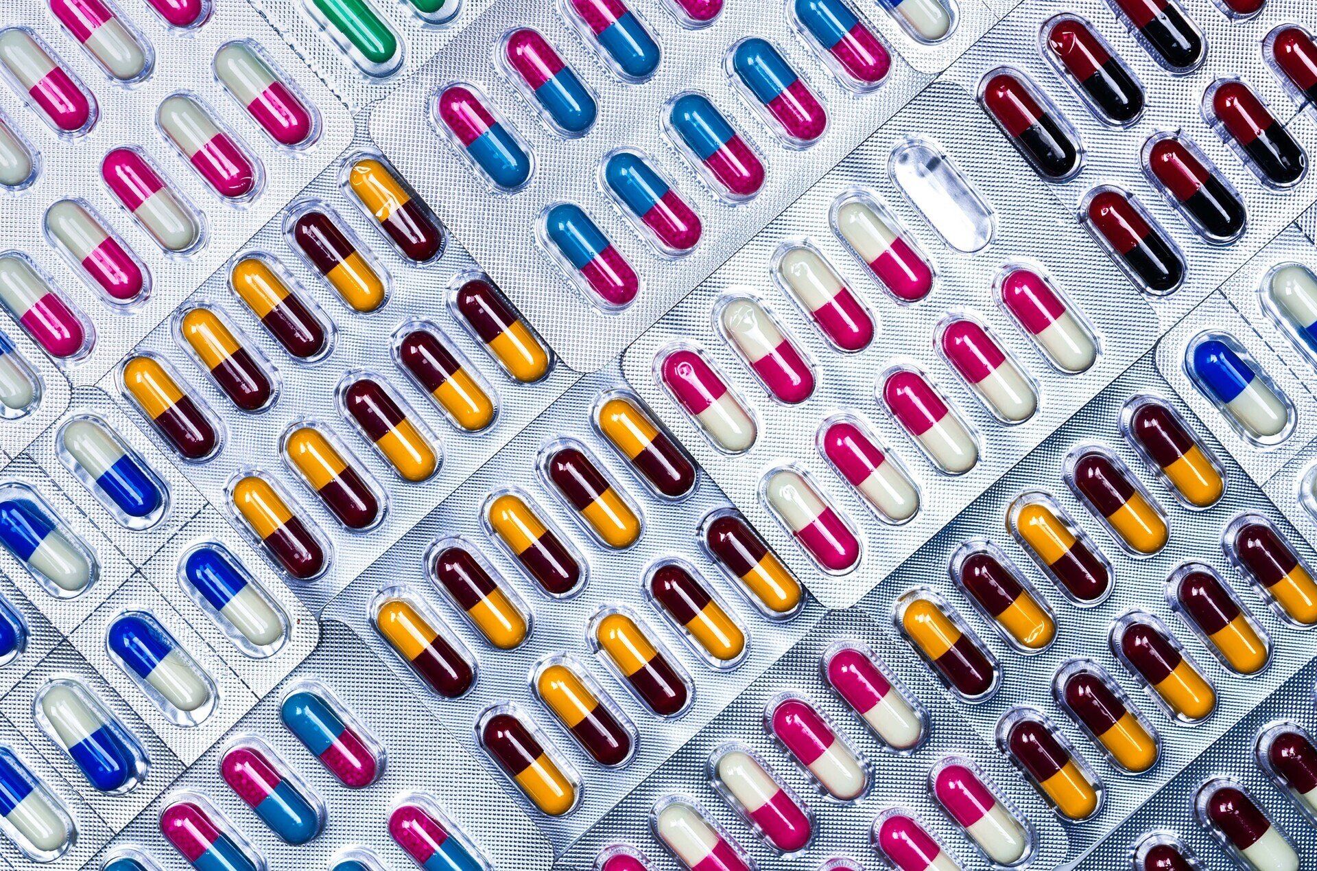 Capsule pills in assorted colors and blister packs.