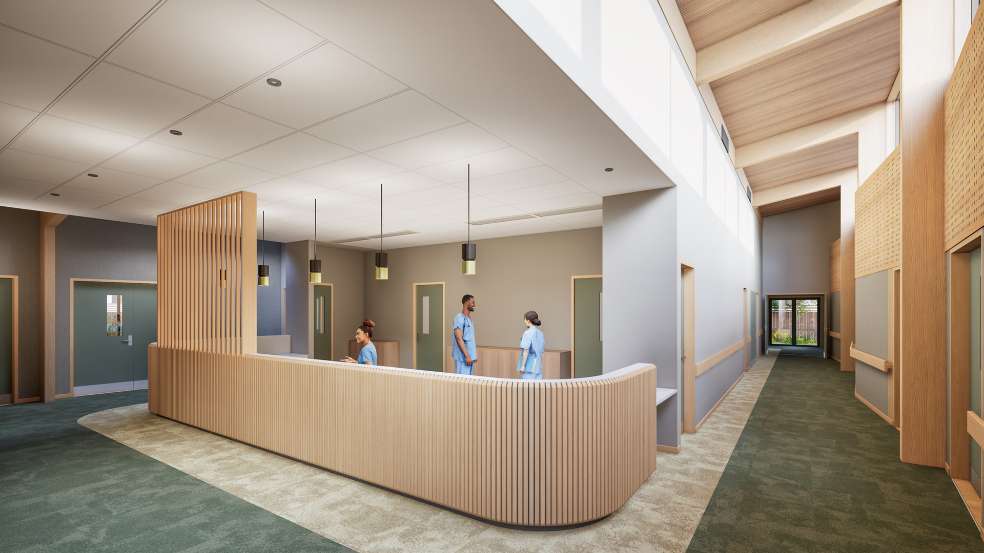 Reception area with wooden counter, staff, and hallway with green carpet.