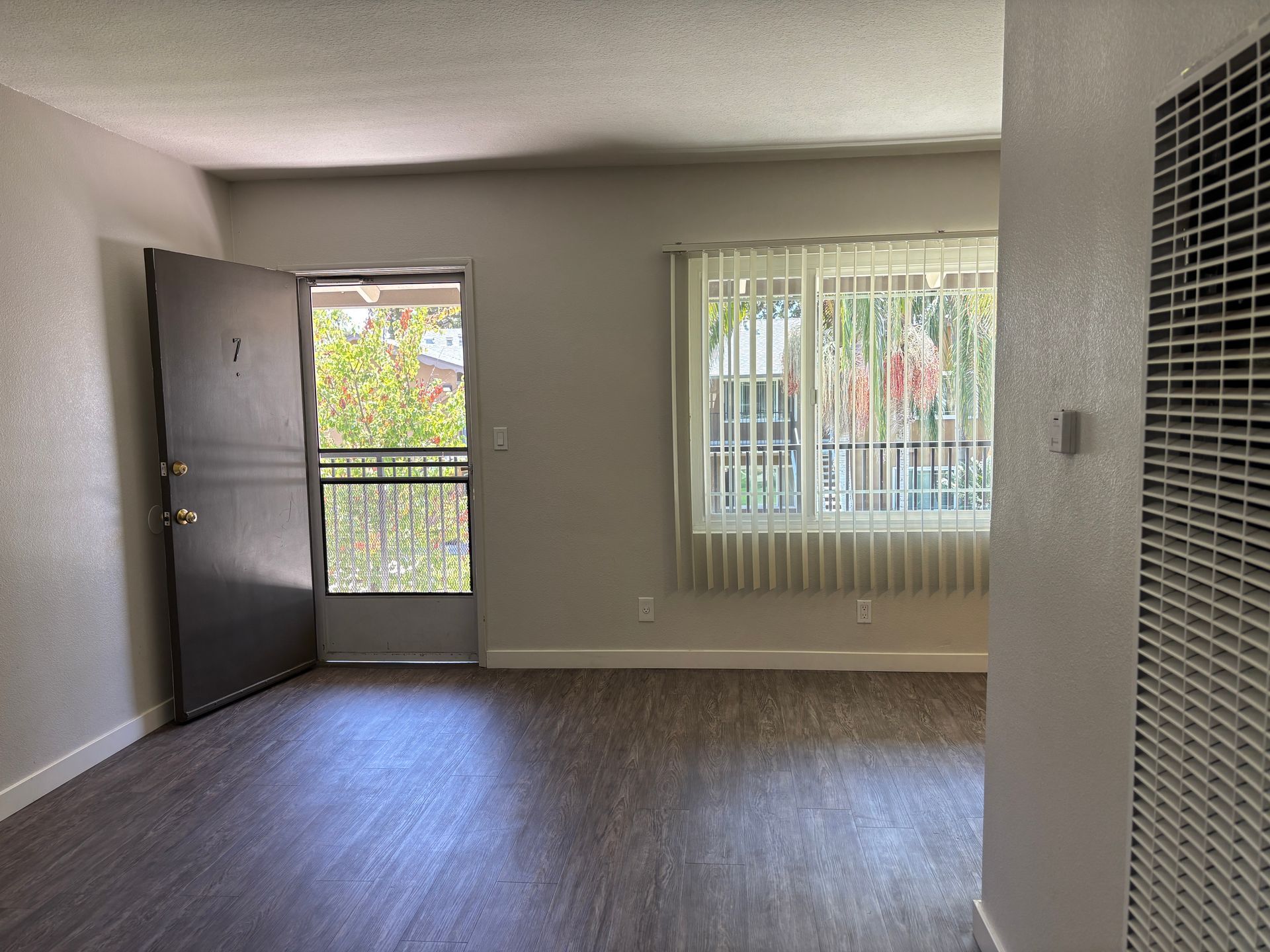living room showing the front door and dining area window