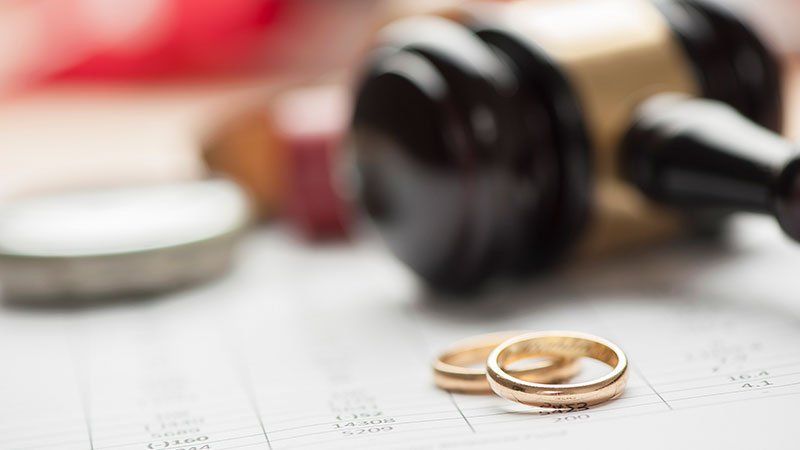 gavel laying next to two rings