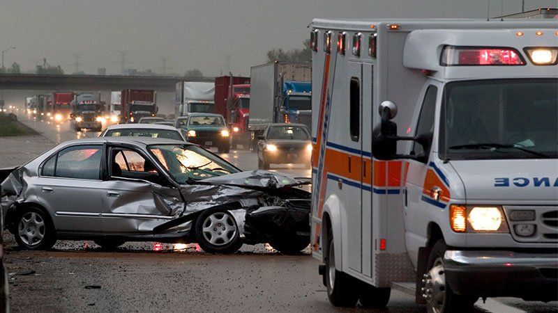 ambulance next to a crashed car