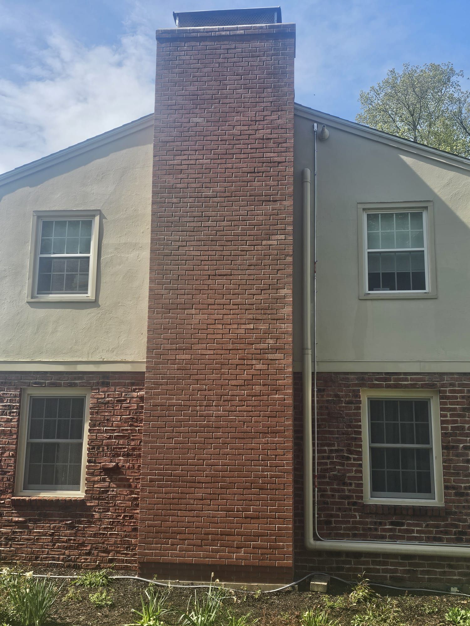 A large brick chimney on the side of a house