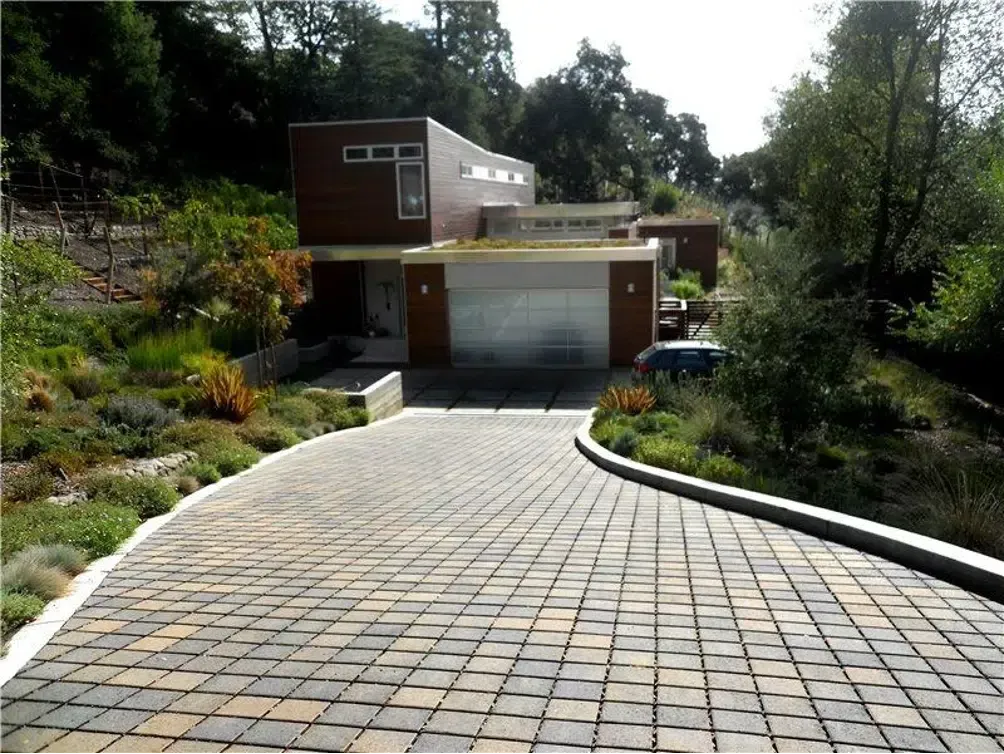 A driveway leading to a house with a garage