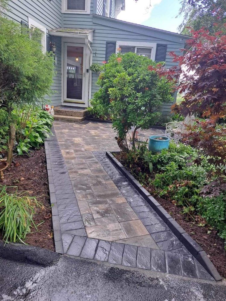 A stone walkway leading to the front door of a house.