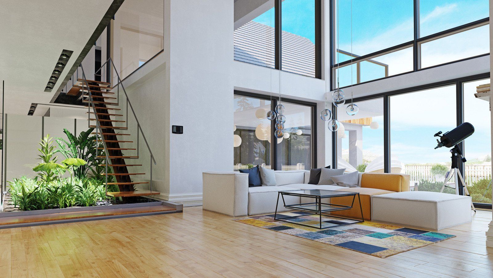 It is a living room with a lot of windows and a staircase.