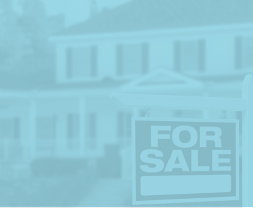 A house with a for sale sign in front of it.