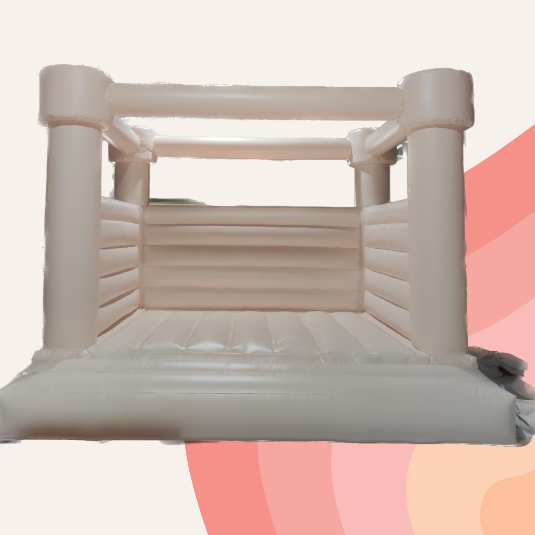 White inflatable bouncy castle with arched roof and padded floor, shown against a pink abstract background