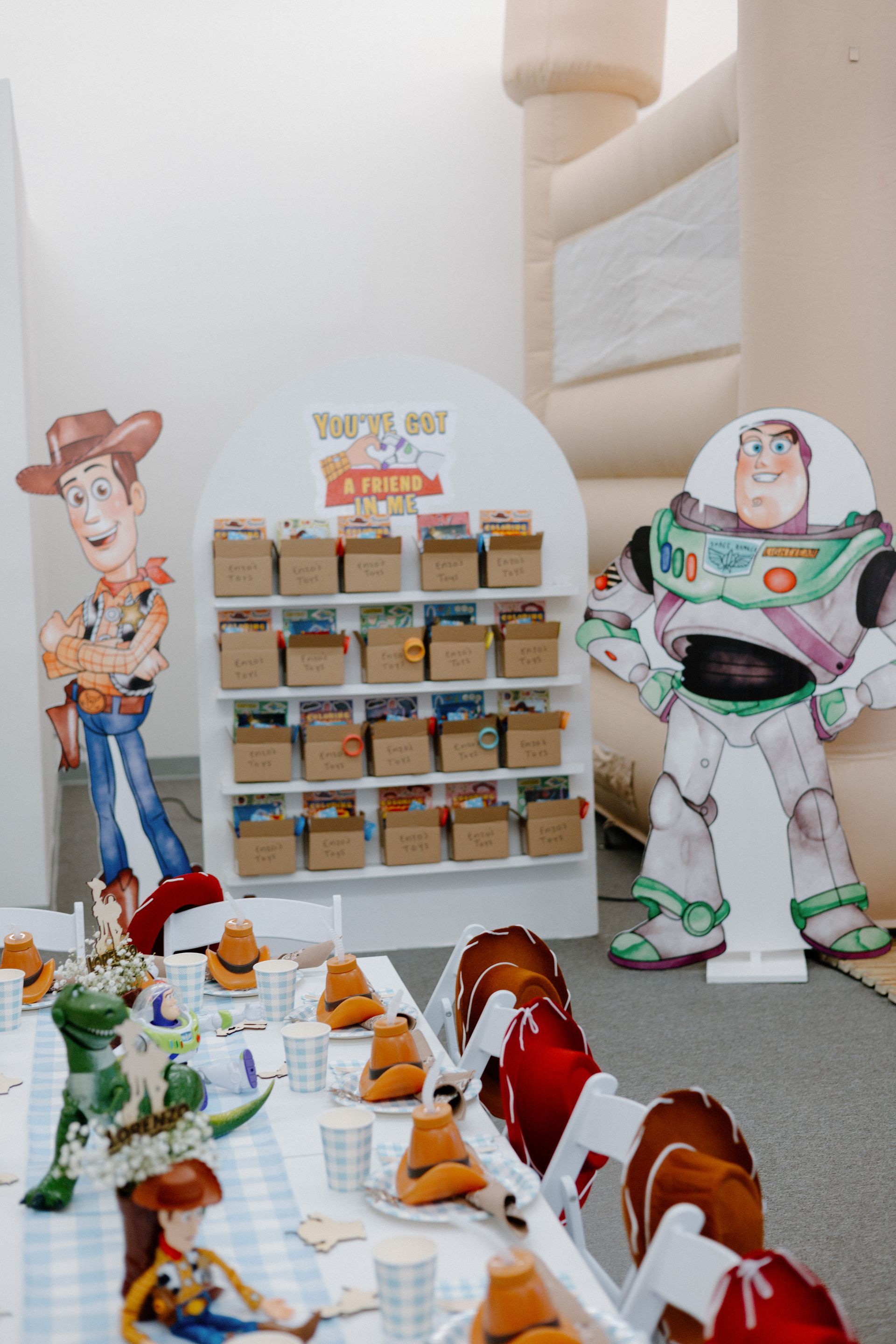 Toy Story display with Woody, Buzz Lightyear, and toy figures arranged on shelves and a table