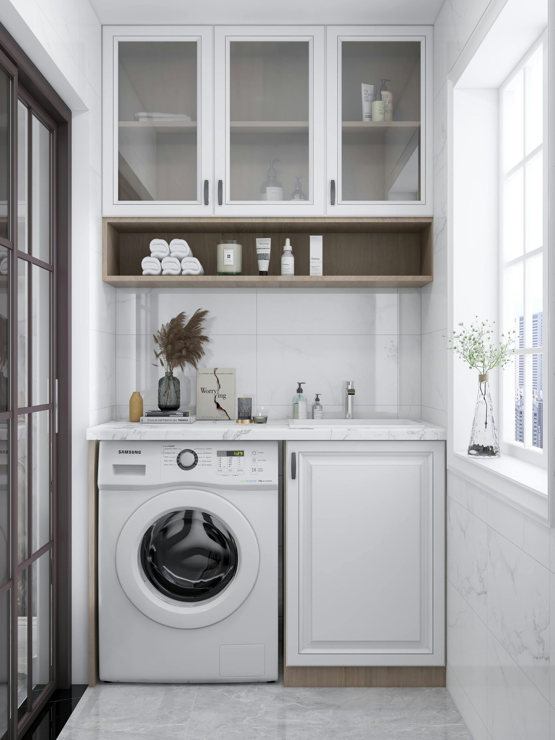 A laundry area with a white washing machine. A laundry area with a white washing machine.