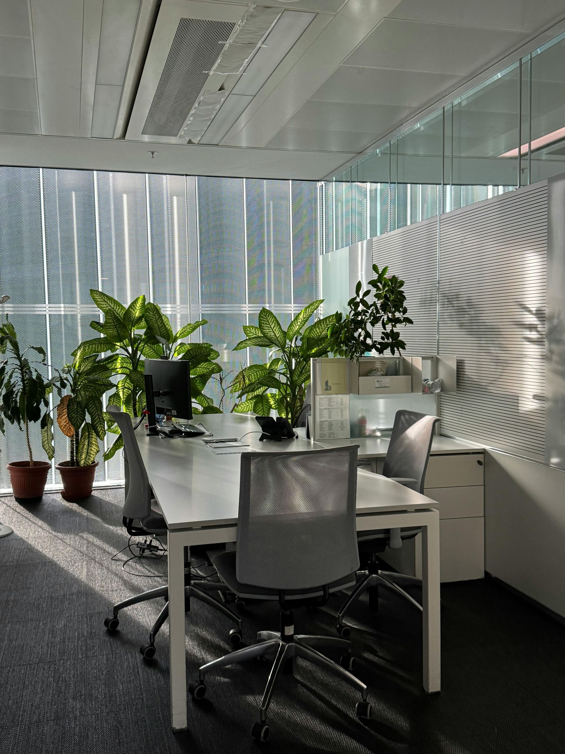A modern office space with a white desk. A modern office space with a white desk.