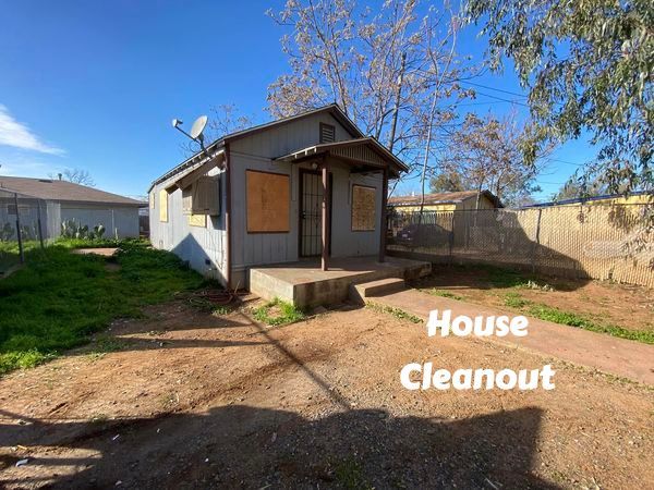 Boarded-up house before a full property cleanout by LJ Junk Away in Oroville, CA