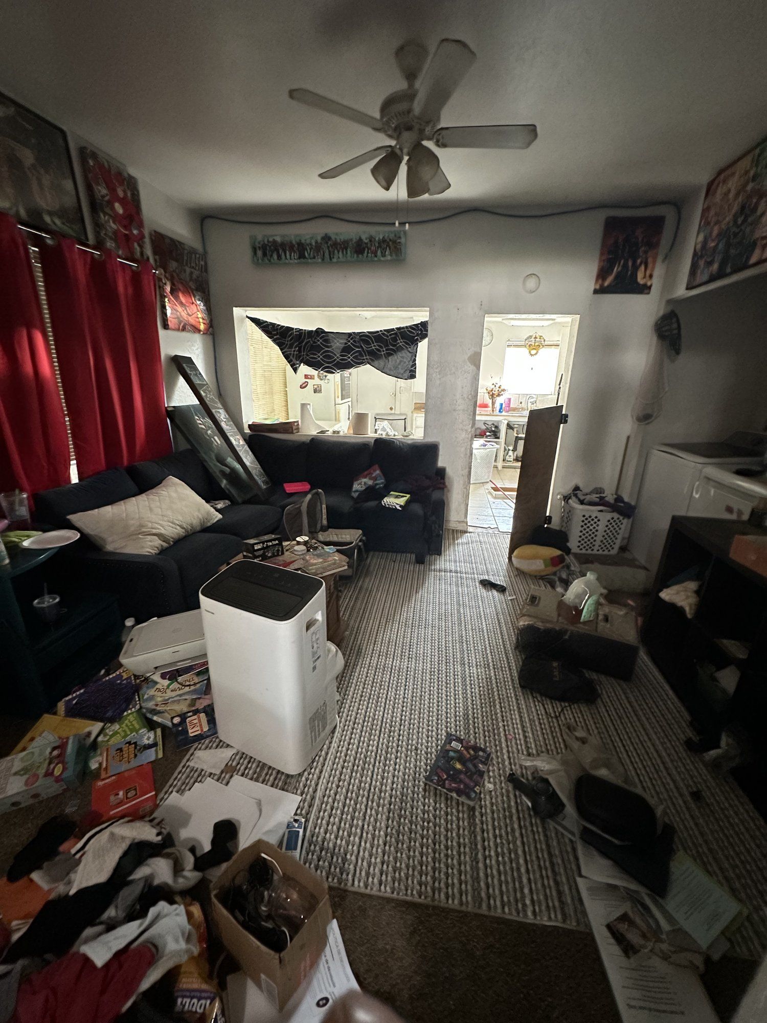 Cluttered living room with furniture and belongings before a house cleanout in Oroville, CA