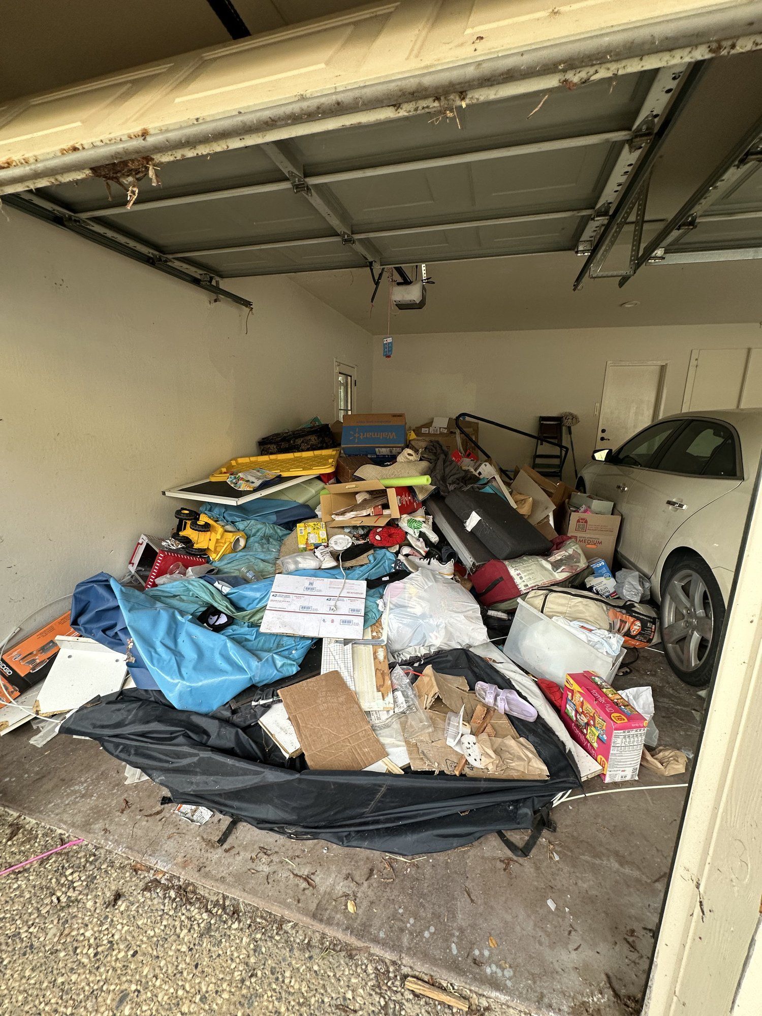 Garage packed with junk before an LJ Junk Away full-service cleanout