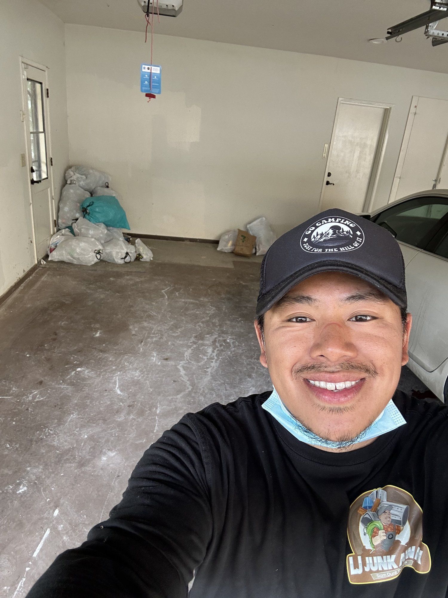 LJ Junk Away owner in a cleaned-out garage after junk removal