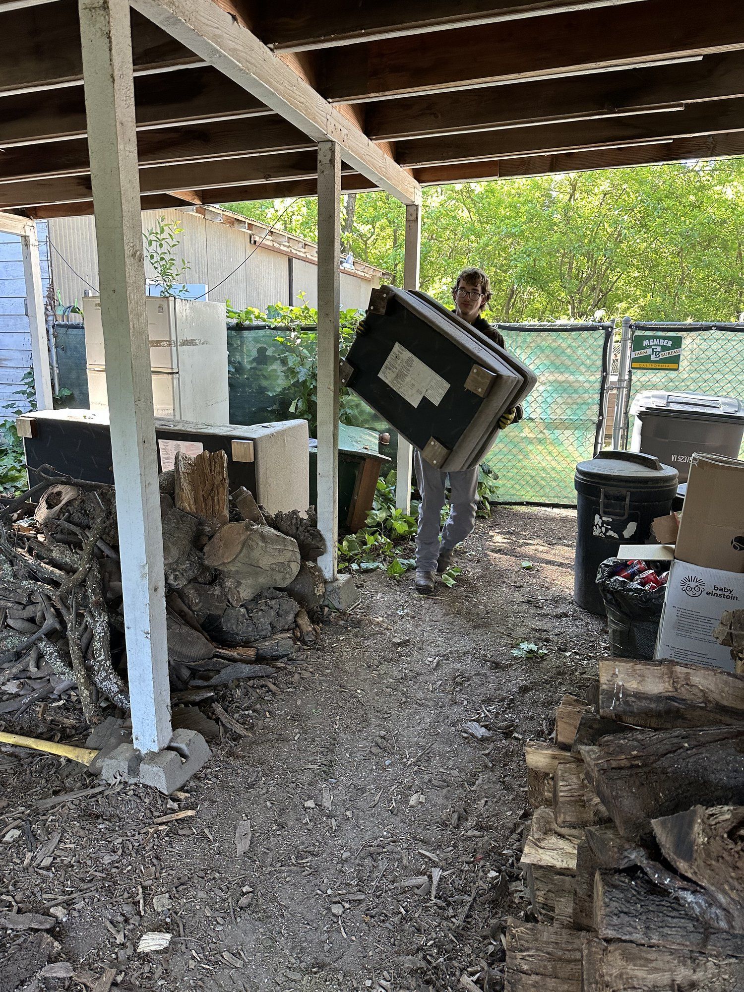 Removing old appliances and debris from a covered patio in Butte County