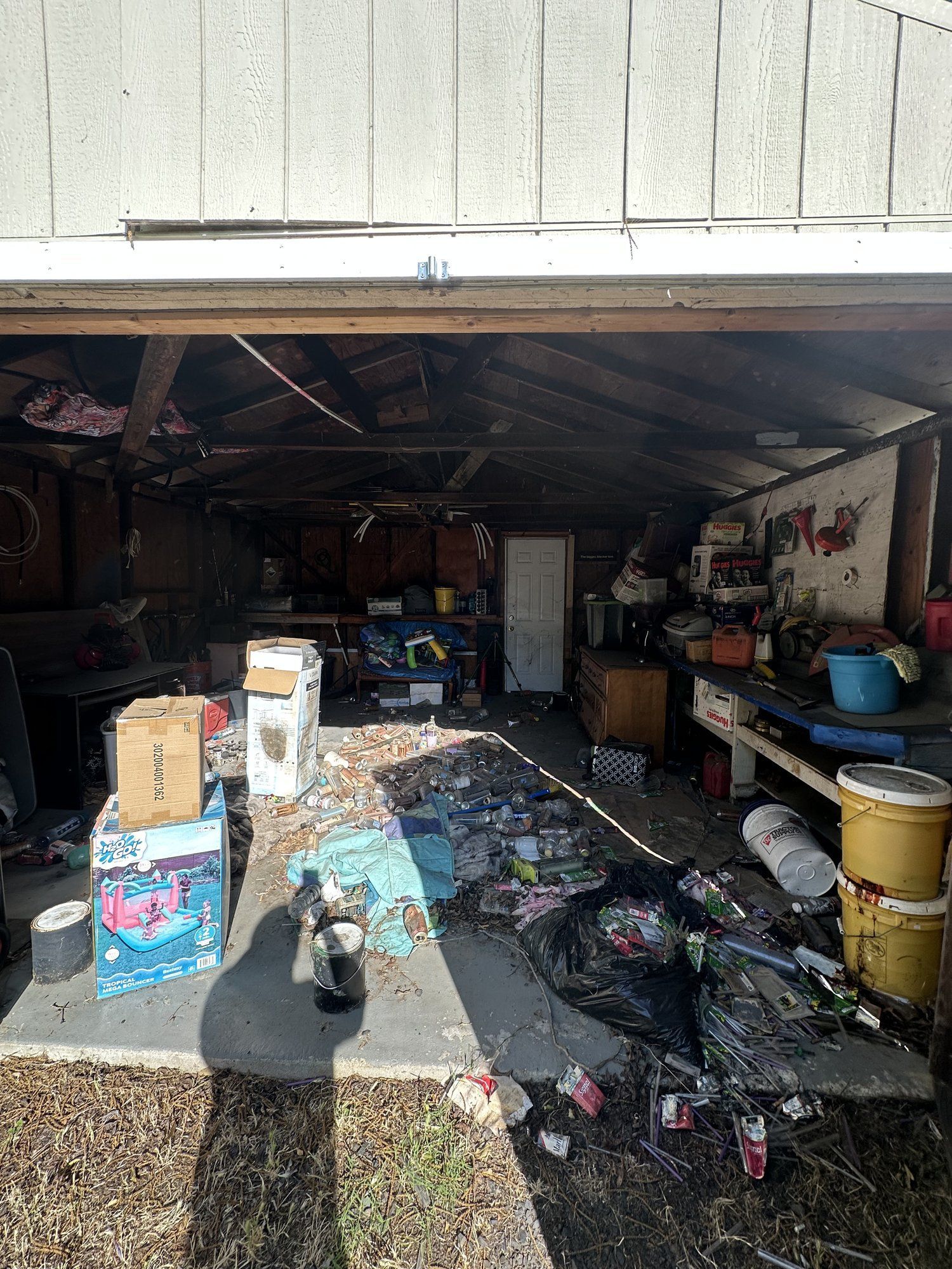Garage cleanout in progress with boxes and household items