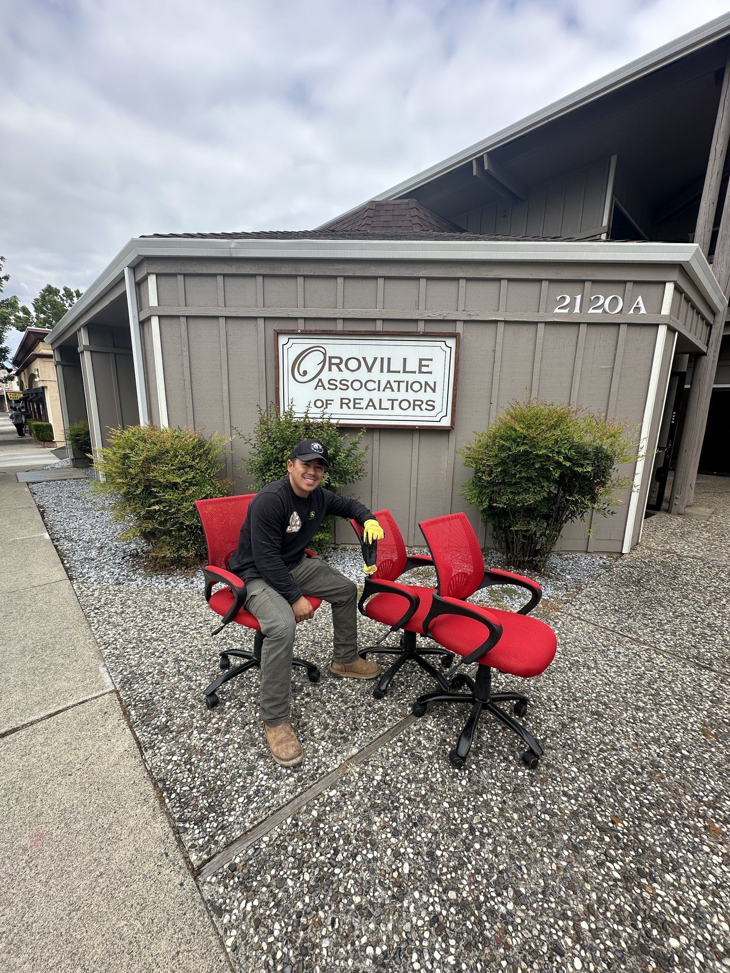 LJ Junk Away owner with office chairs outside a commercial cleanout job in Oroville