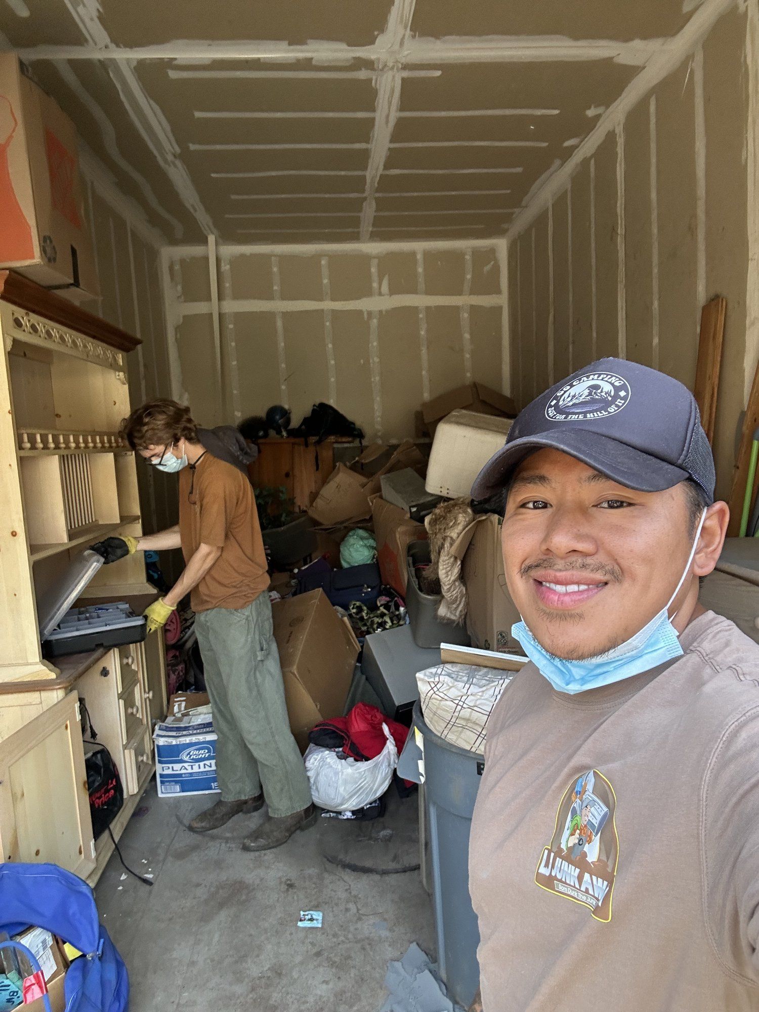 LJ Junk Away crew clearing a packed storage unit