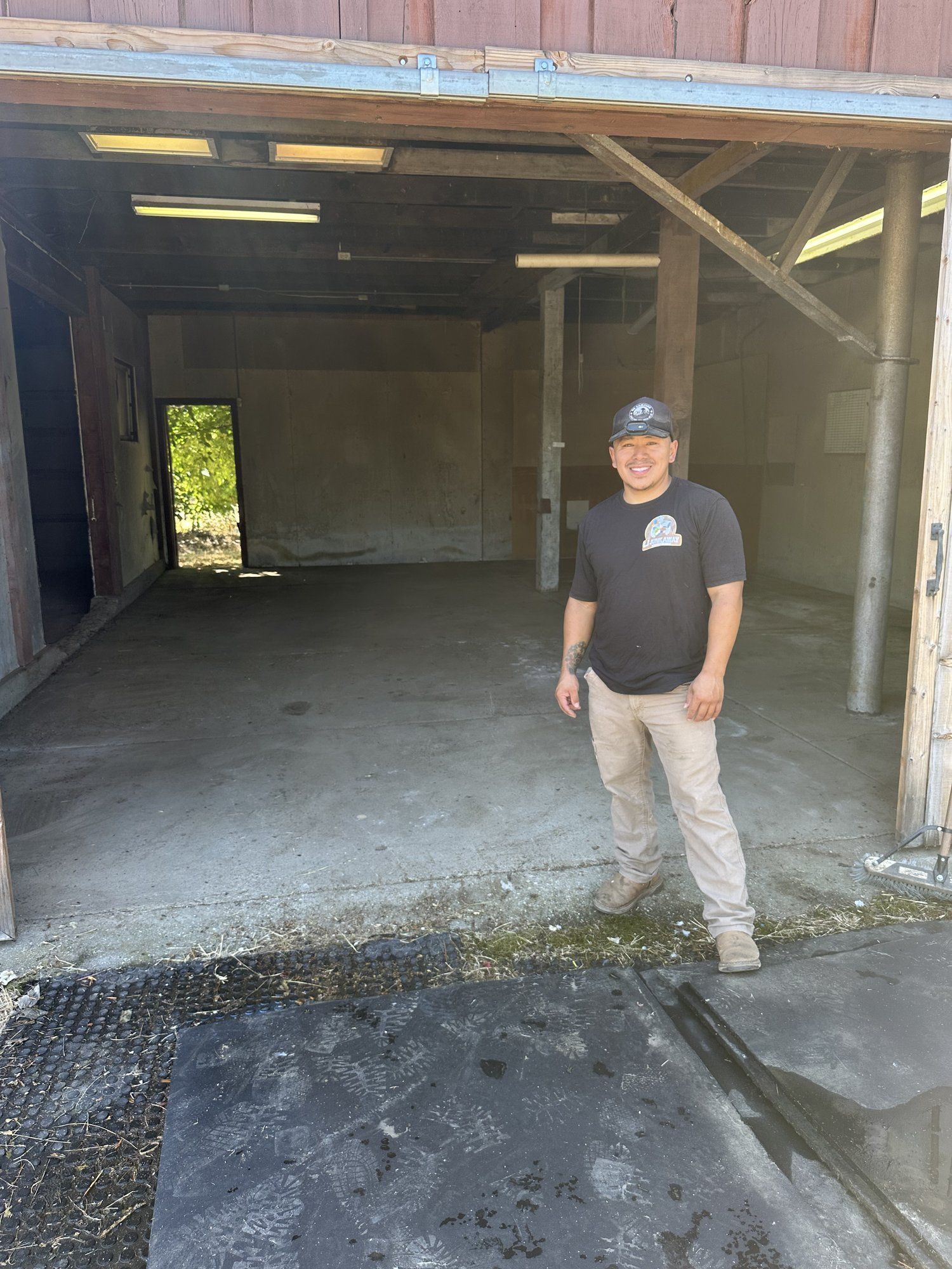 LJ Junk Away crew member in a cleaned-out backyard shed