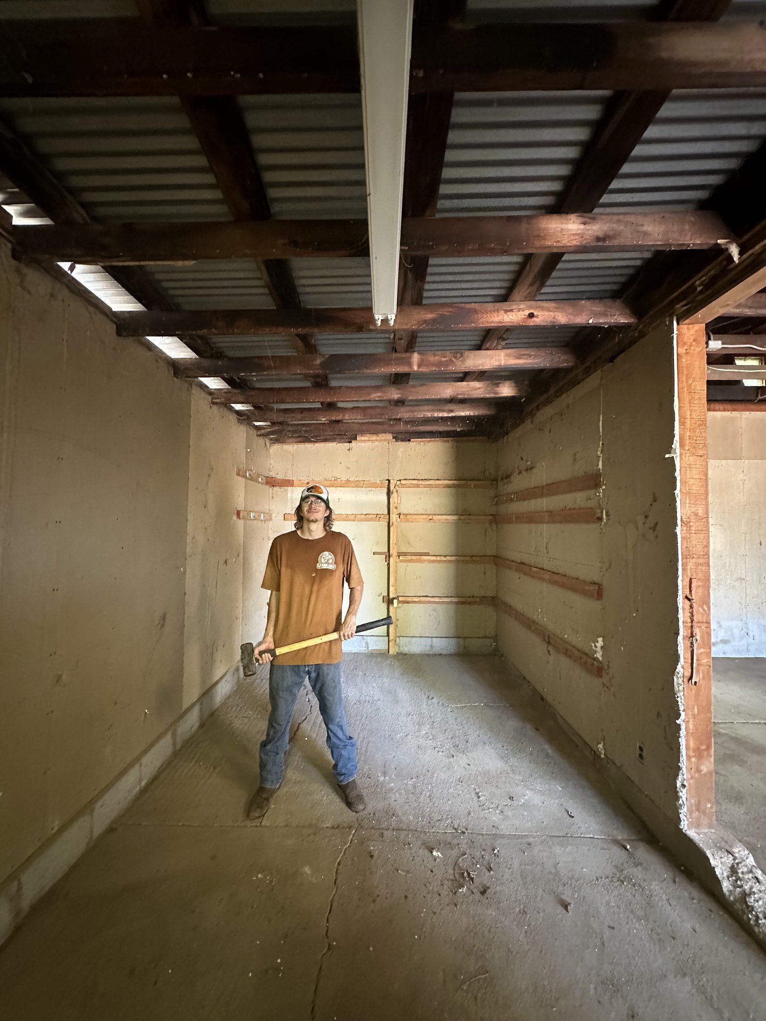 Crew clearing a shed interior before demolition