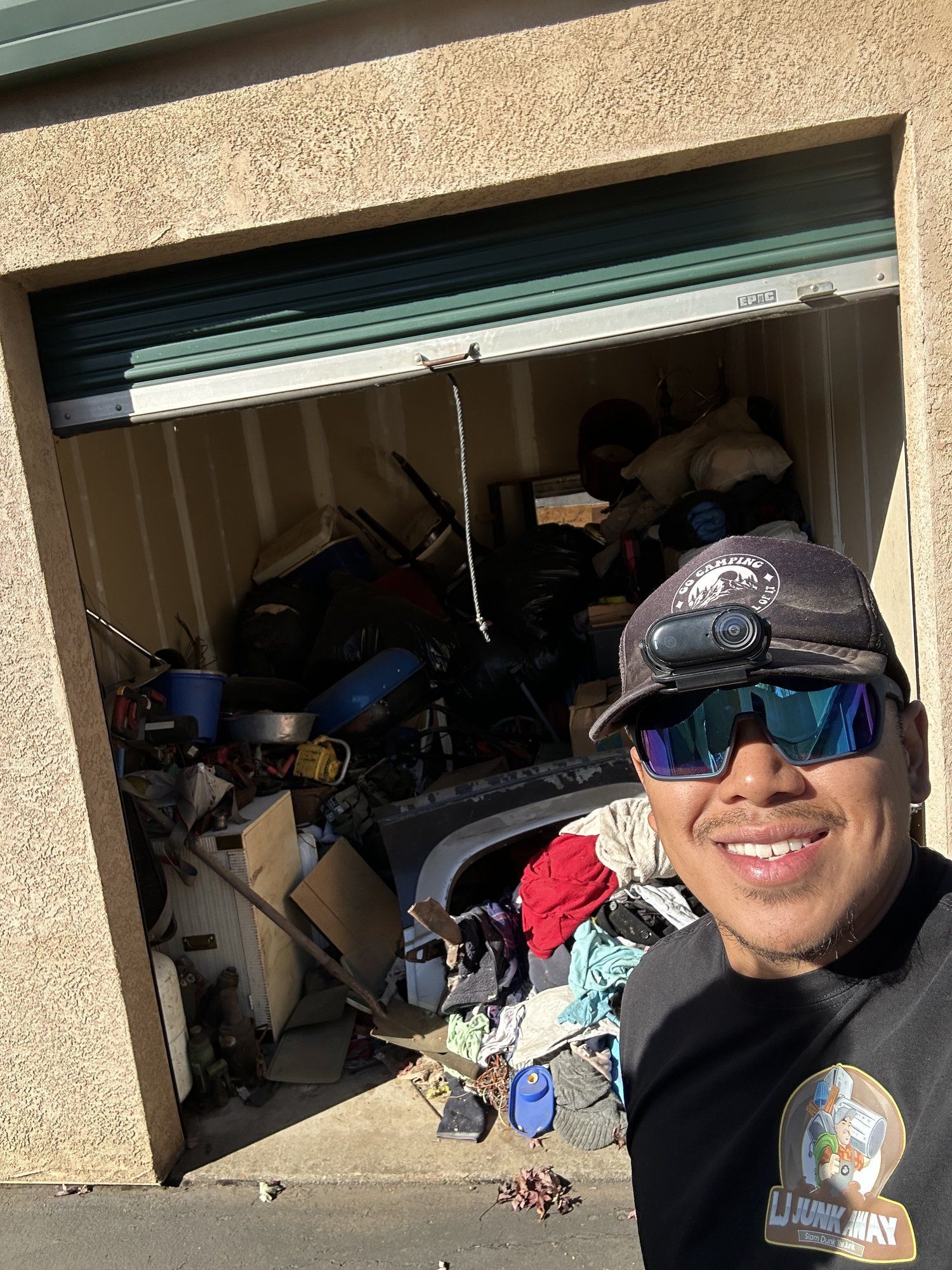 LJ Junk Away owner in front of a storage unit before cleanout