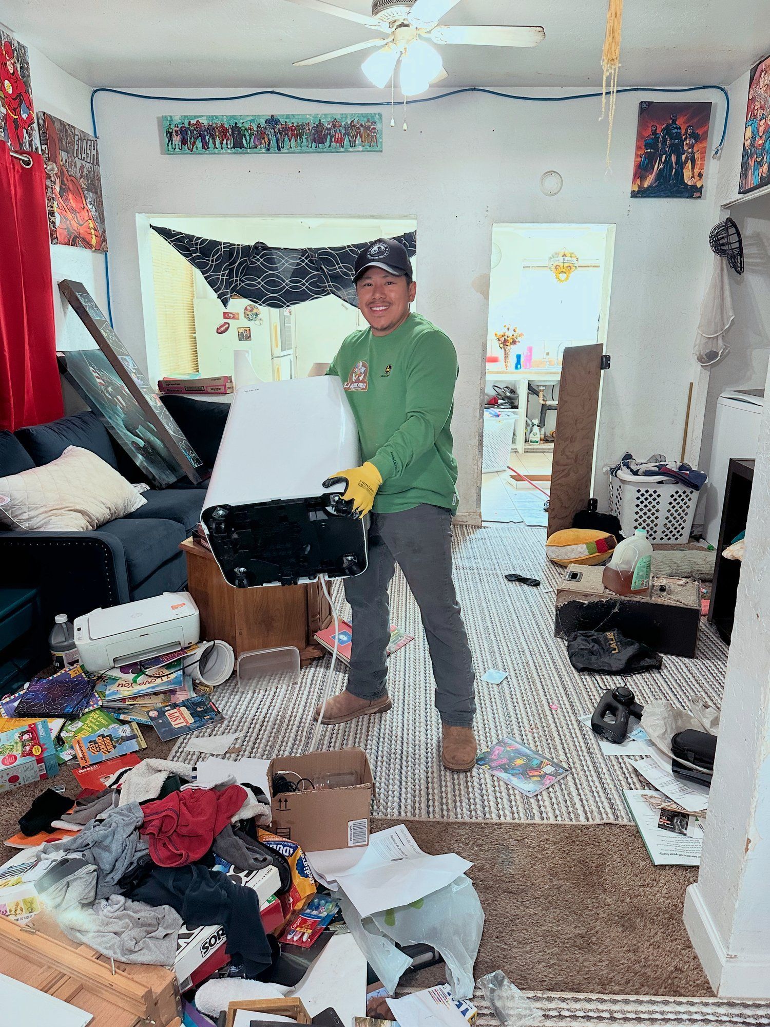 Crew member in a cluttered living room before a house cleanout