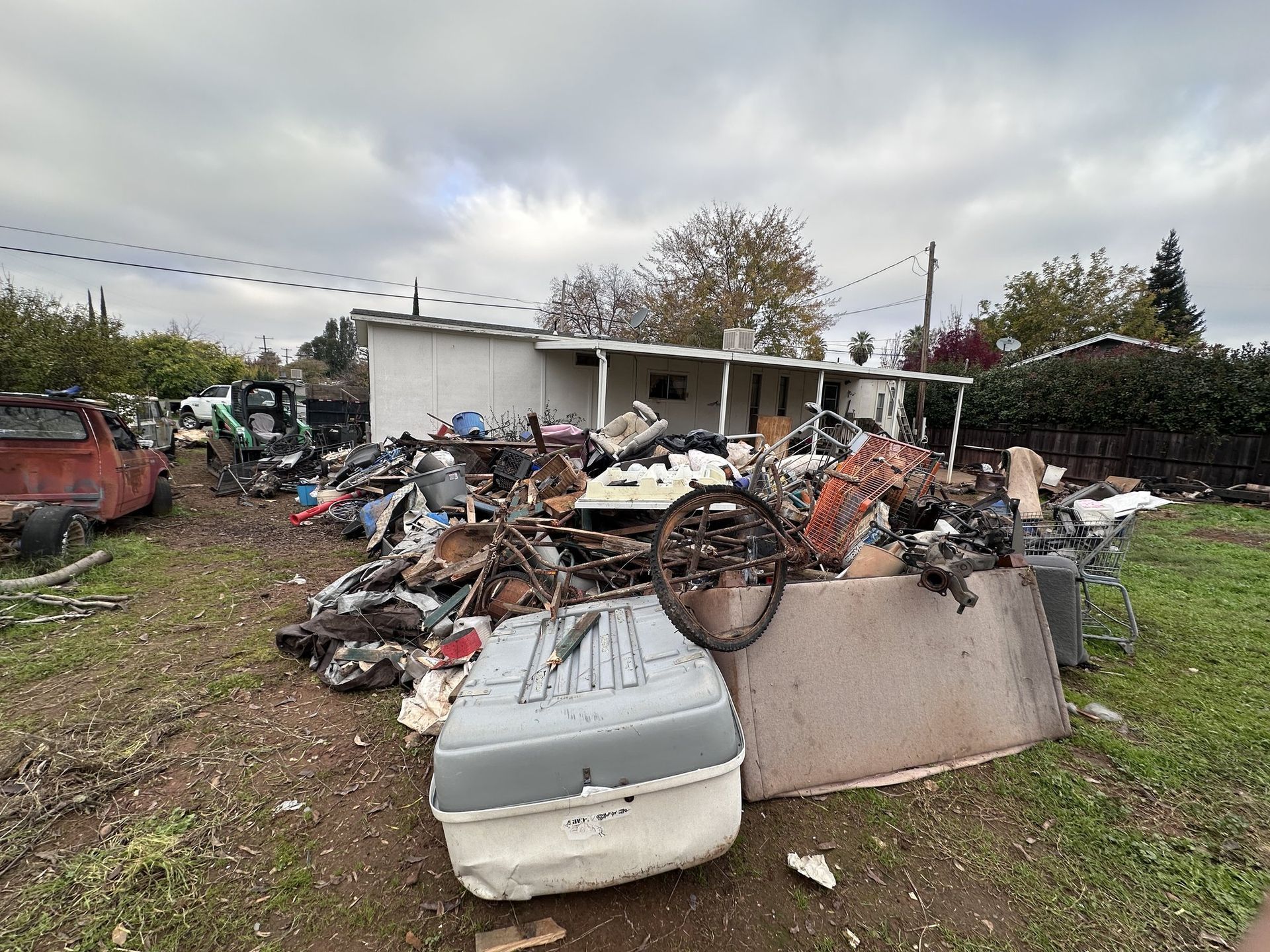 Backyard full of scrap metal and appliances before junk removal