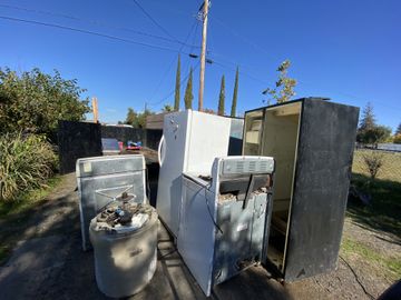 Old appliances and refrigerators staged for haul away by LJ Junk Away