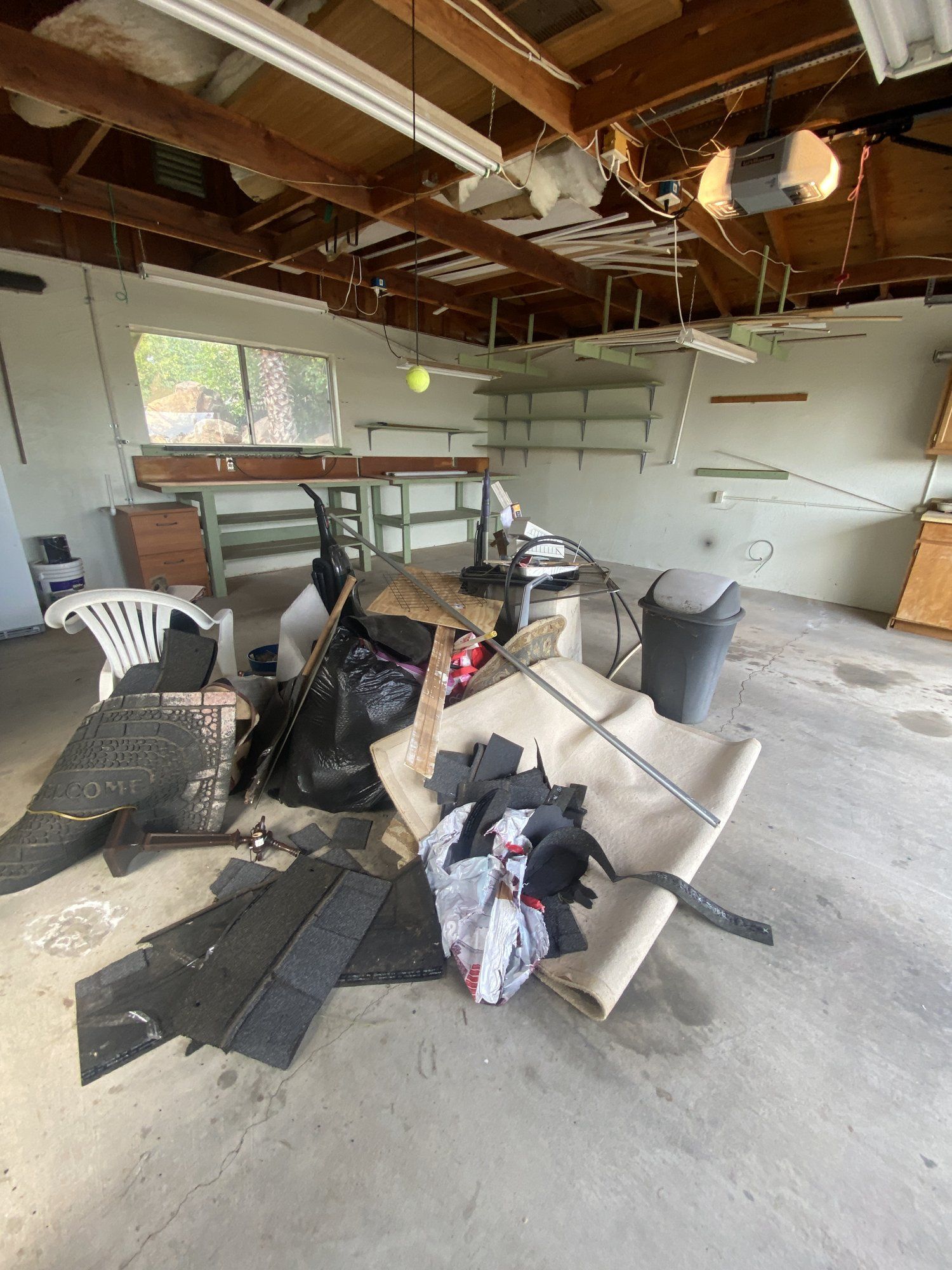 Garage packed with furniture and junk before cleanout