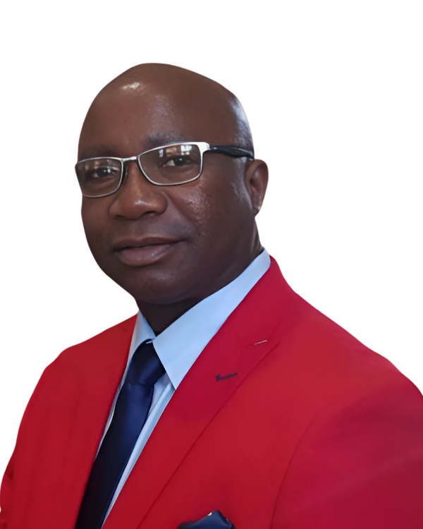 Man in red blazer, glasses, and blue tie, smiling slightly.
