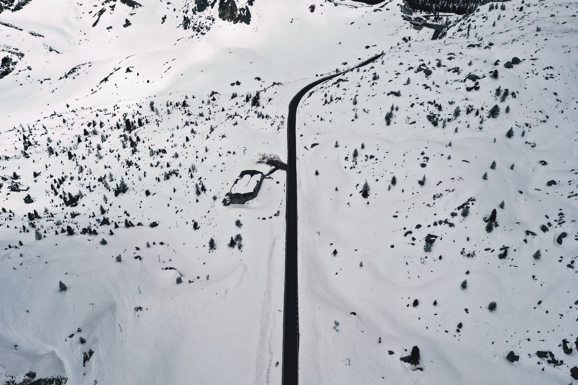 areal view of snowy scape. Road is clear and clean of ice.