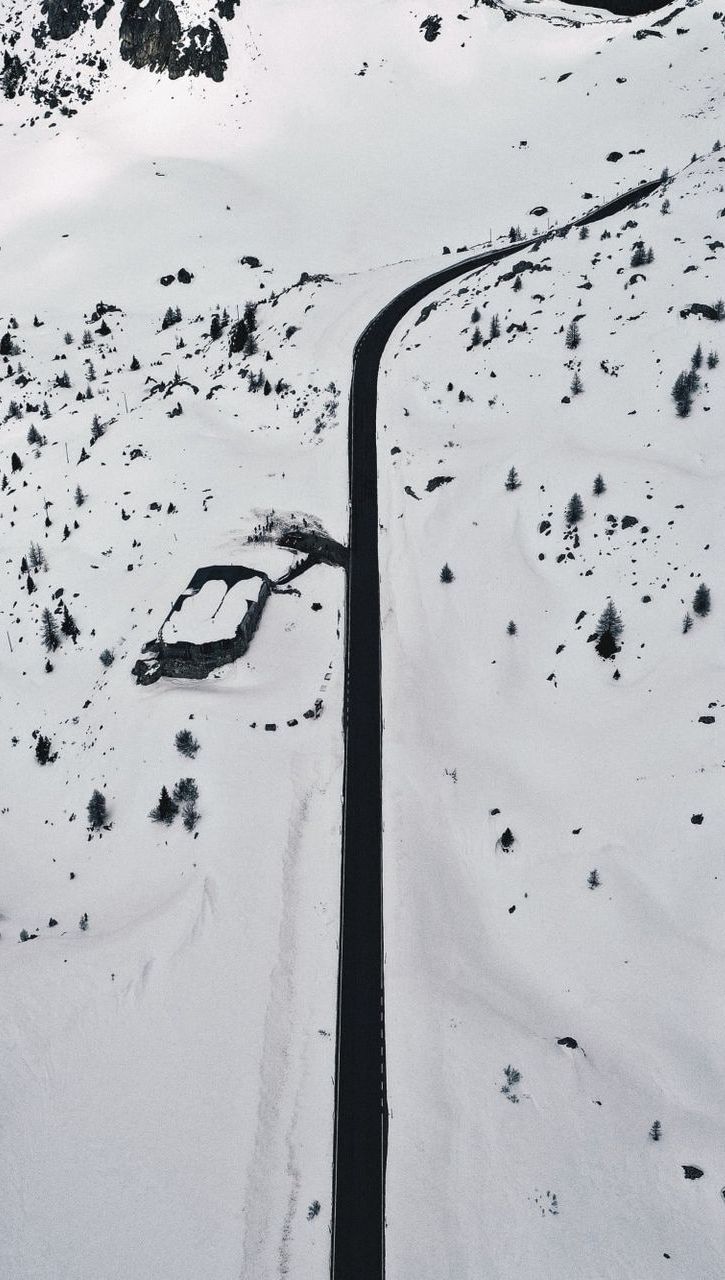 areal view of snowy plane with clear road