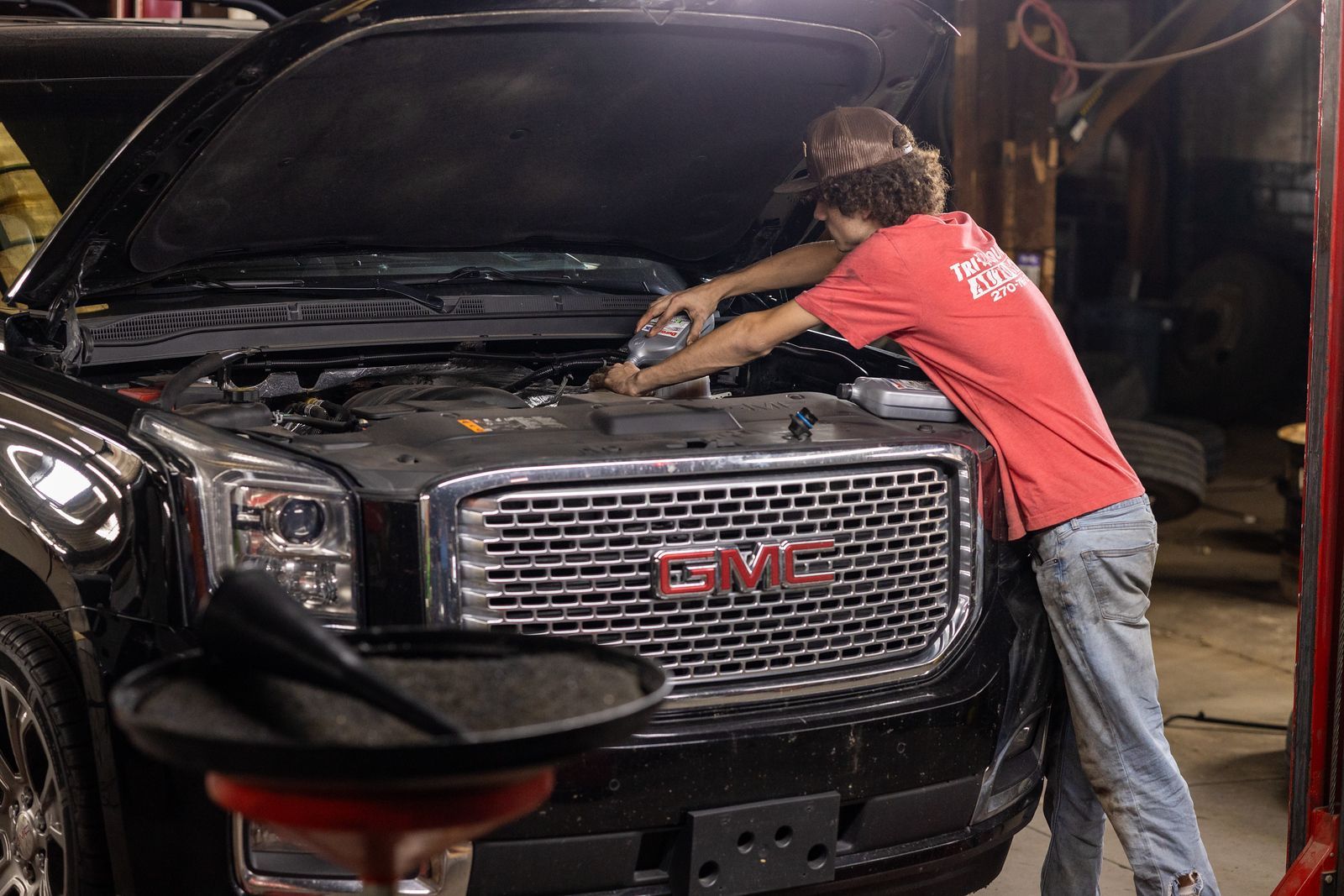 A service mechanic is working on a gmc truck