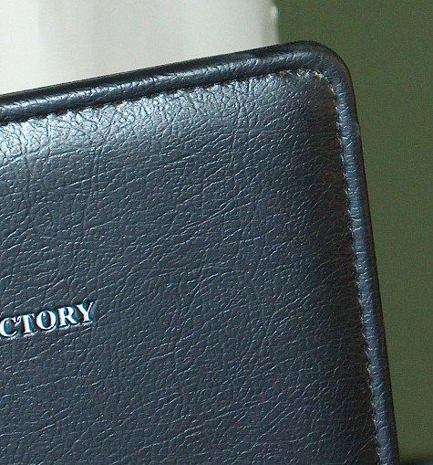 A black leather wallet with the word directory on it