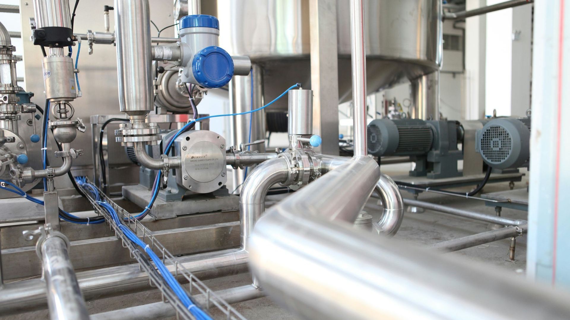 A factory with a lot of pipes and machinery.