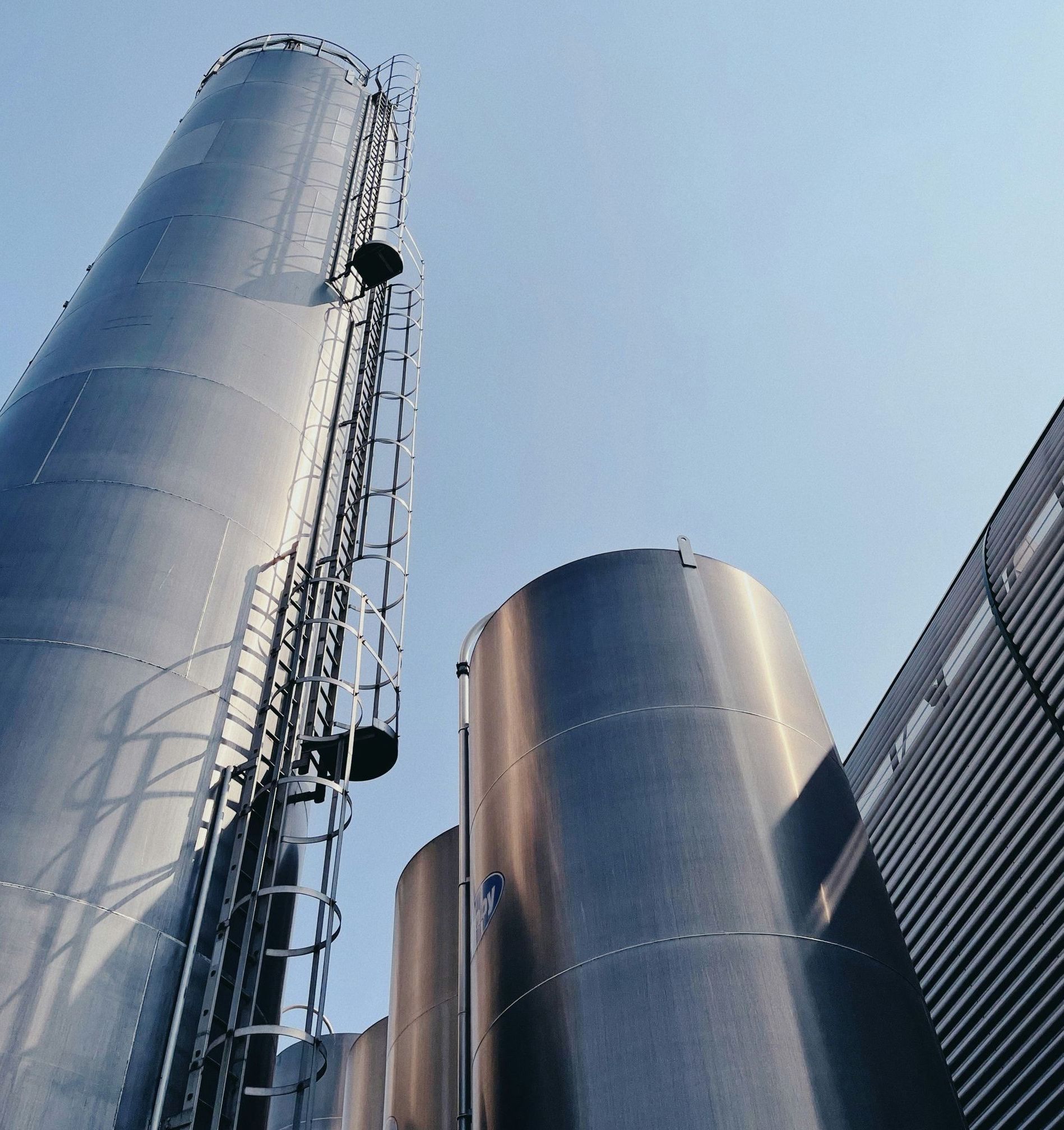 A large stainless steel tower with a ladder attached to it