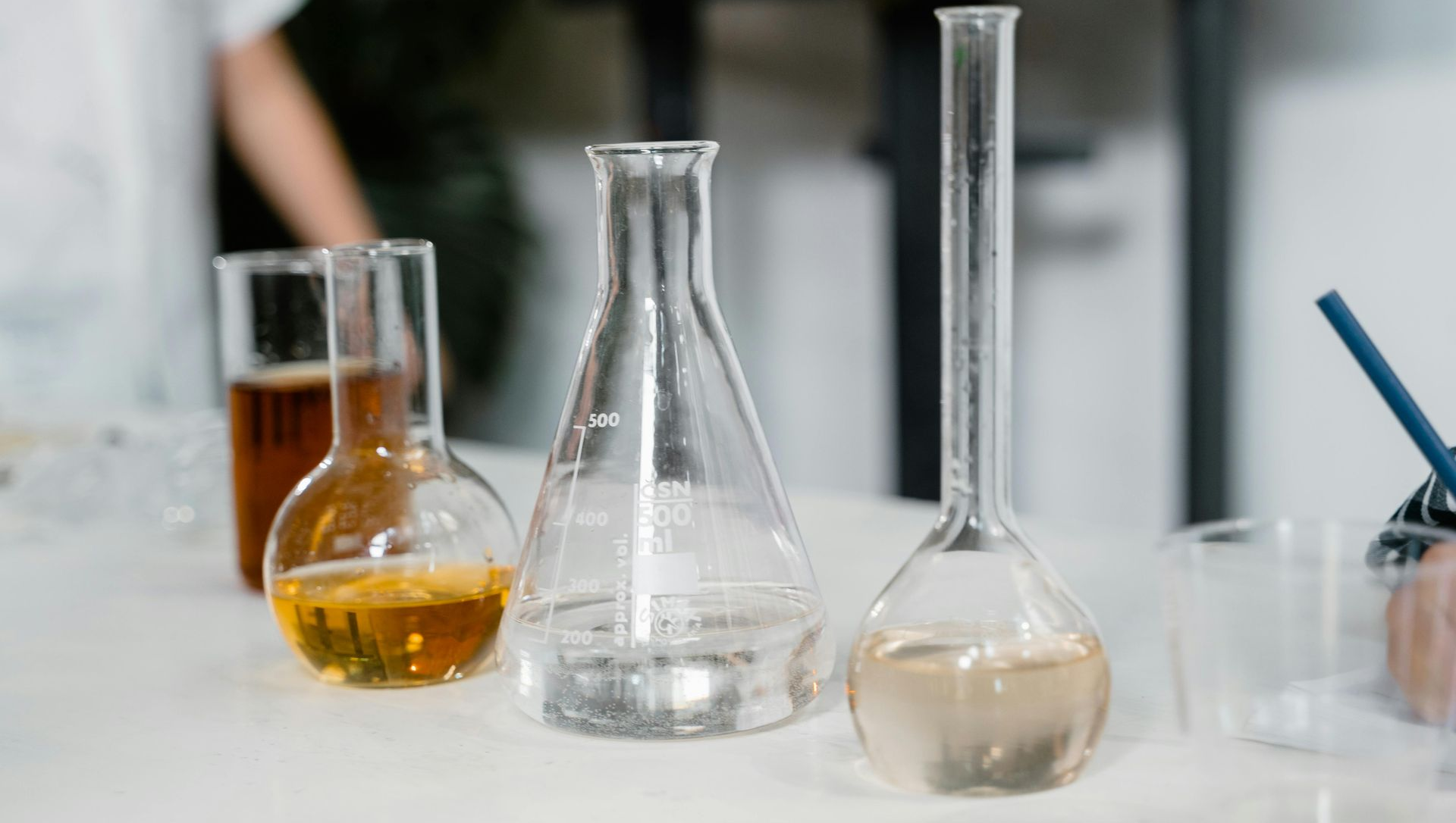 Laboratory glassware containing various colored liquids.