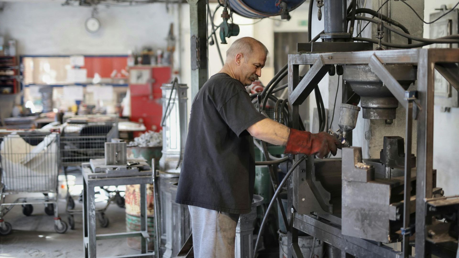 A man is working on a machine in a factory.