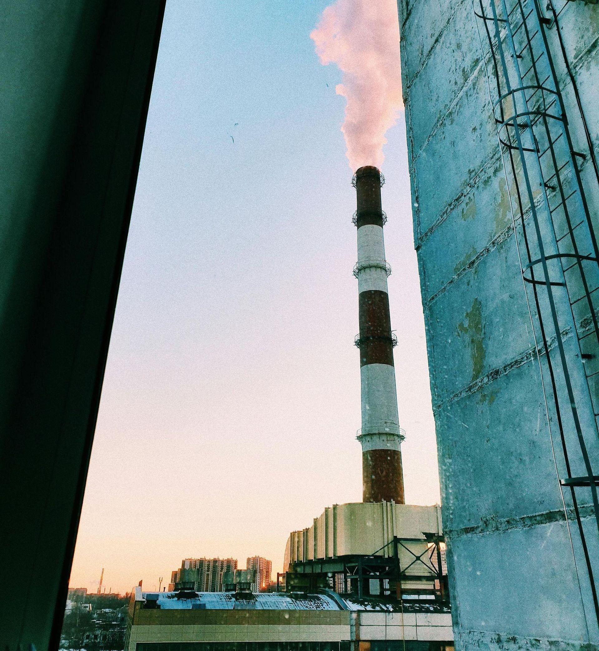 A large chimney with smoke coming out of it