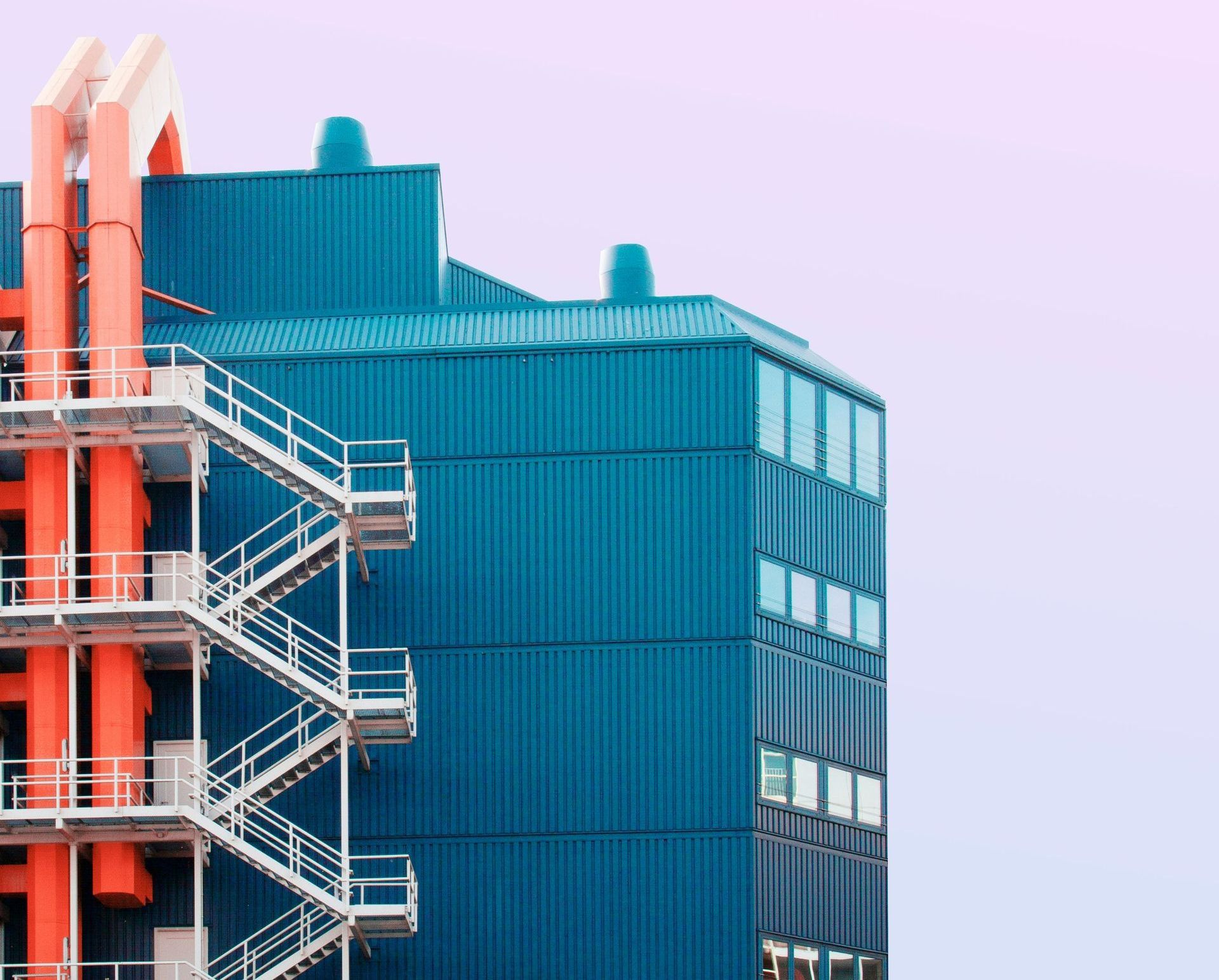 A blue building with stairs on the side of it.