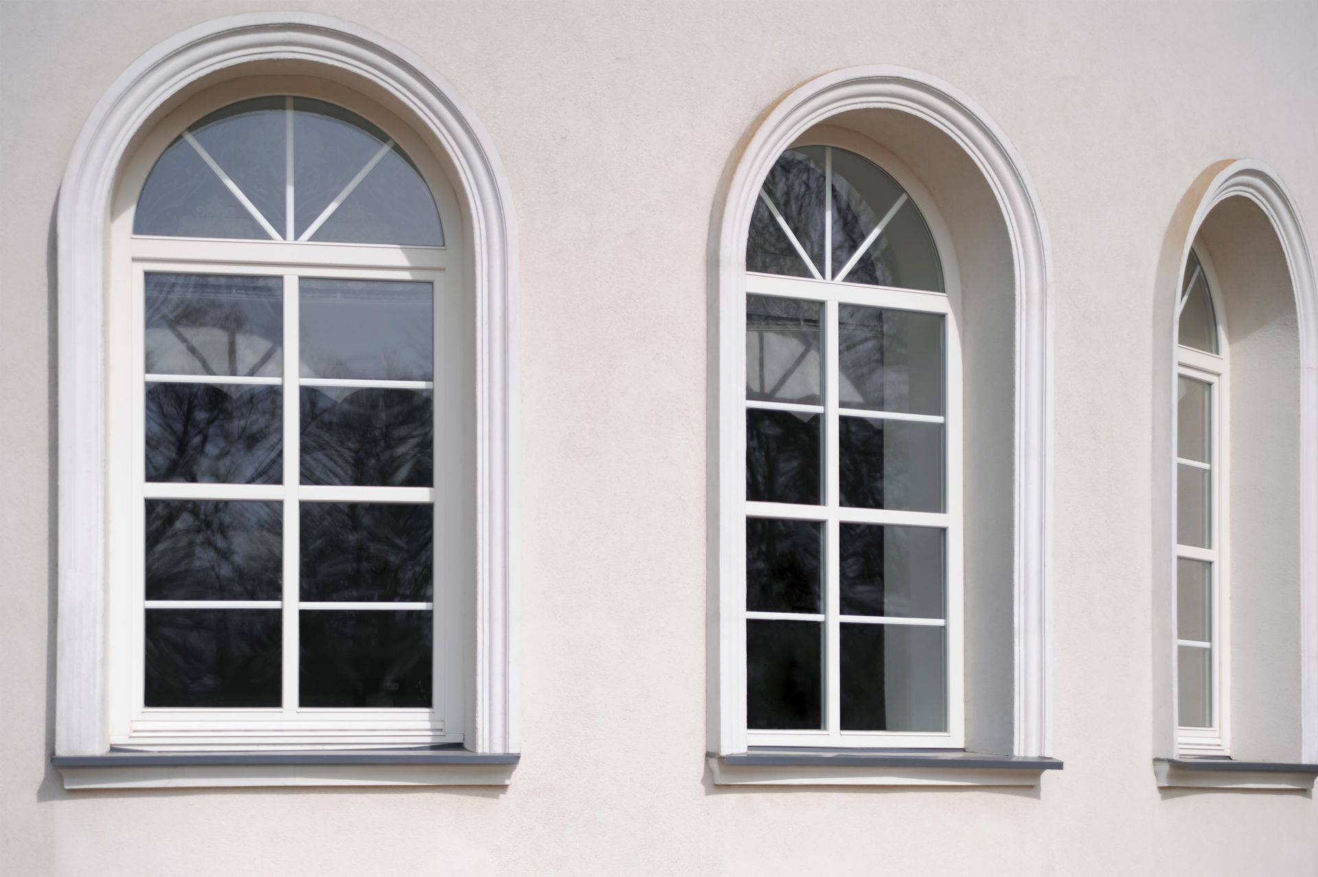 Three arched windows on the side of a building