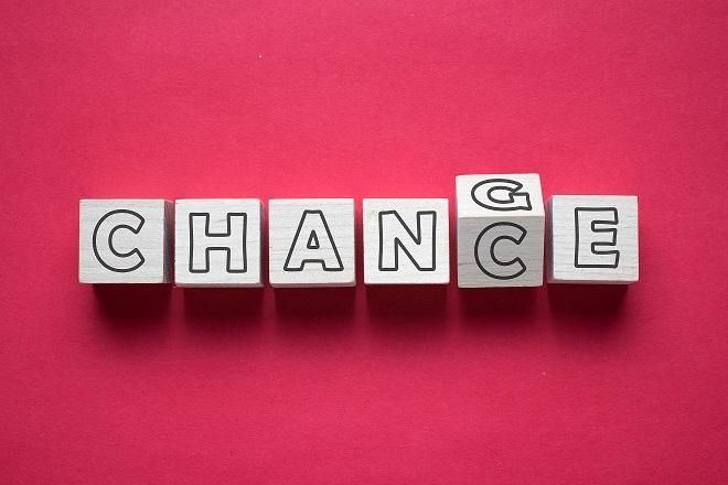 Letter blocks spelling “CHANGE” on a pink background