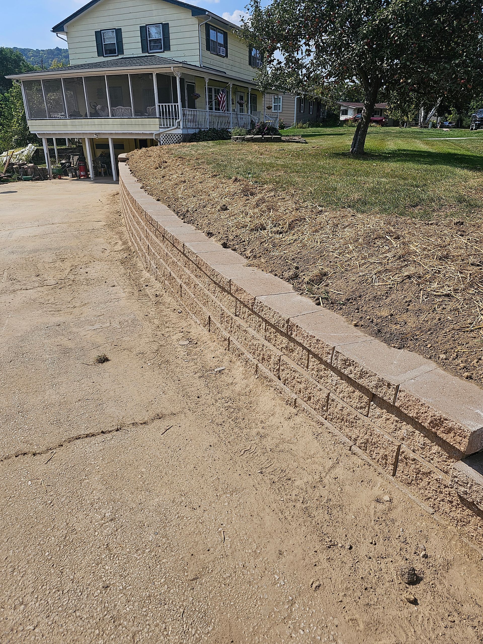 A large house with a lot of dirt in front of it.