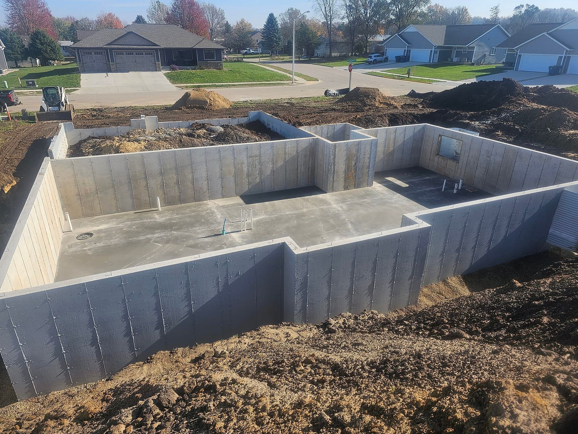 A concrete foundation is being built in a residential area