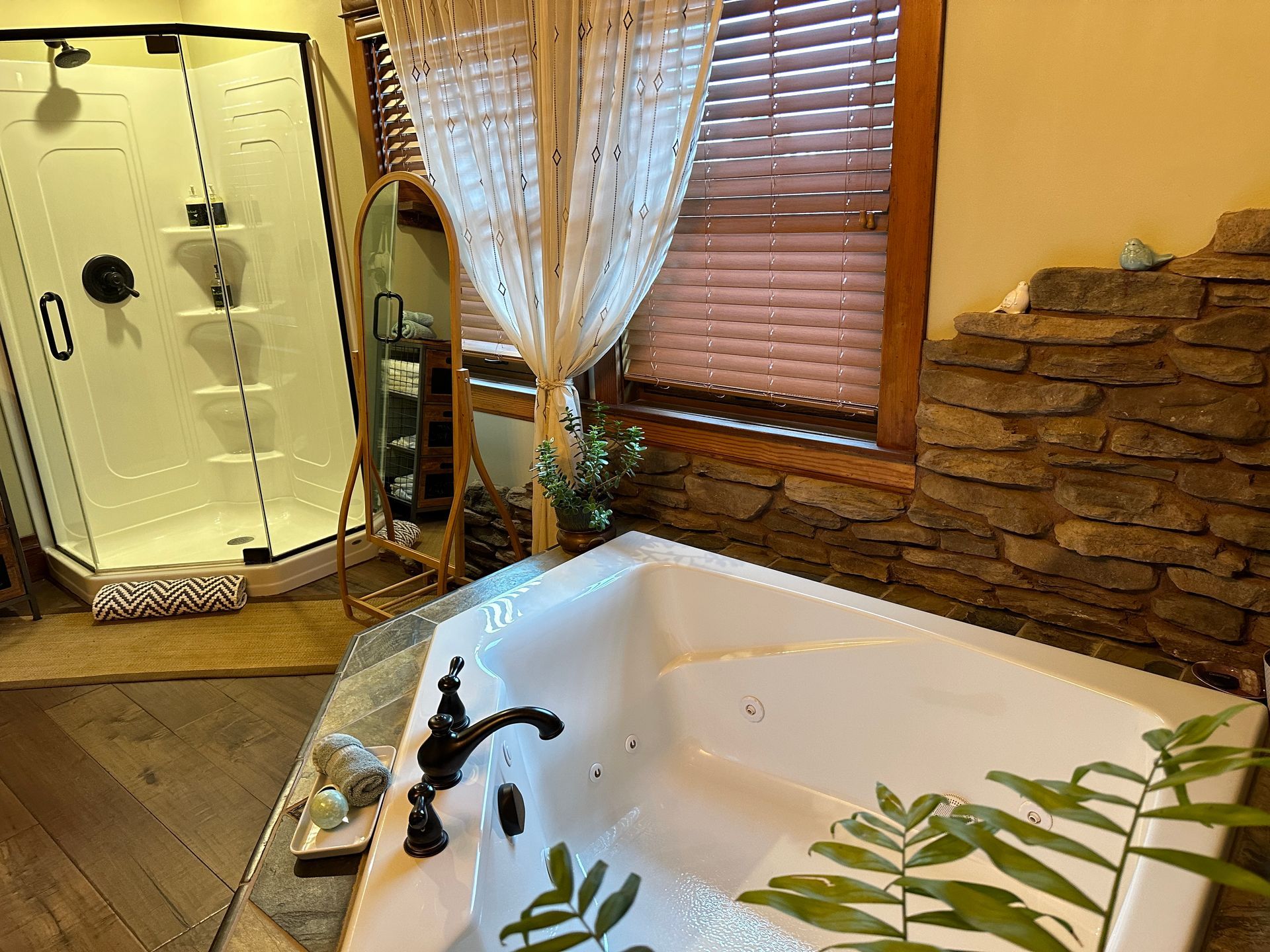 A bathroom with a jacuzzi tub and a shower.