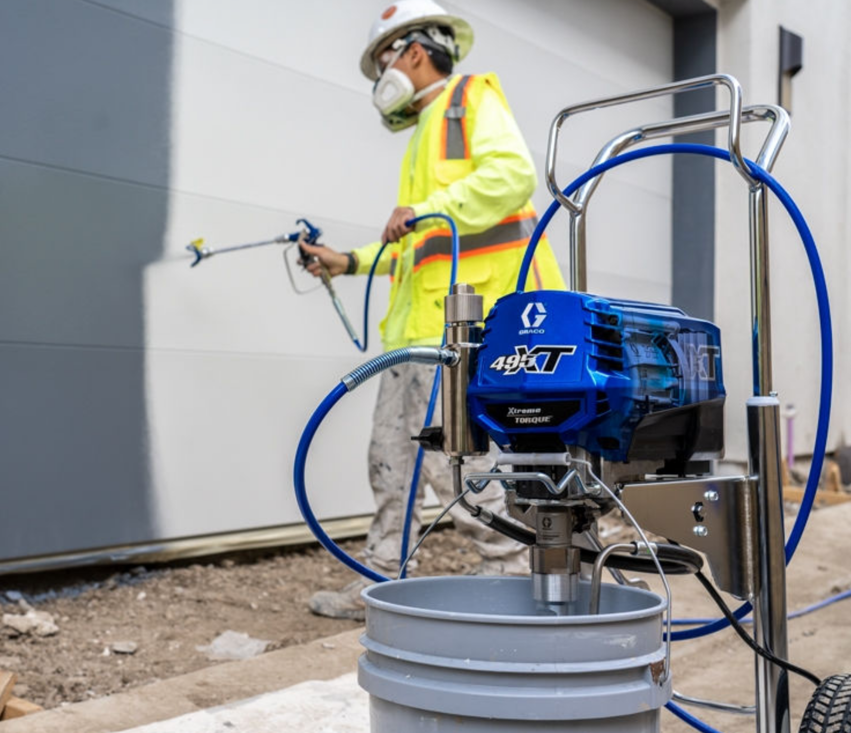 A professional painter using a Graco paint sprayer at Stevens Paint & Blinds near Vestal and Corning, New York (NY)